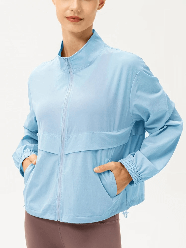 Light blue women's UV protection running windbreaker SF1916, lightweight and breathable with turn-down collar for outdoor activities.